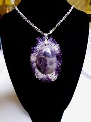 Amethyst stone wrapped in jean fringe