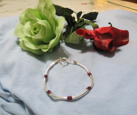 Curved tube bracelet with real rubies