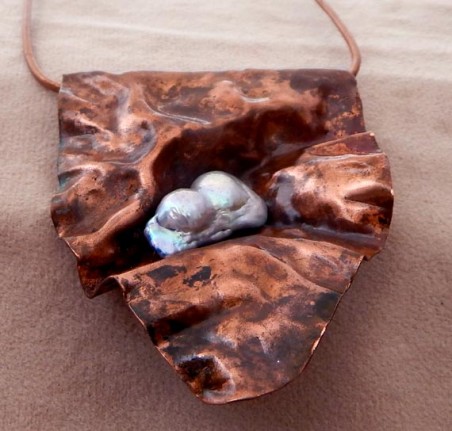 This is formfolded scrap copper with an unusual fresh water pearl wired into it