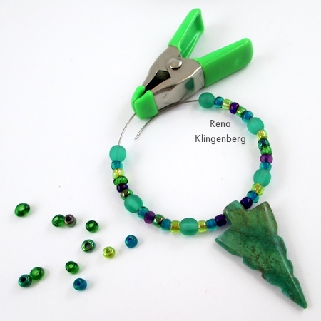 Use a clip to prevent beads from sliding off the wire - Memory Wire Pendant and Earrings - Tutorial by Rena Klingenberg