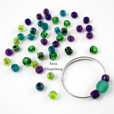 Start adding seed beads around the focal - Memory Wire Pendant and Earrings - Tutorial by Rena Klingenberg